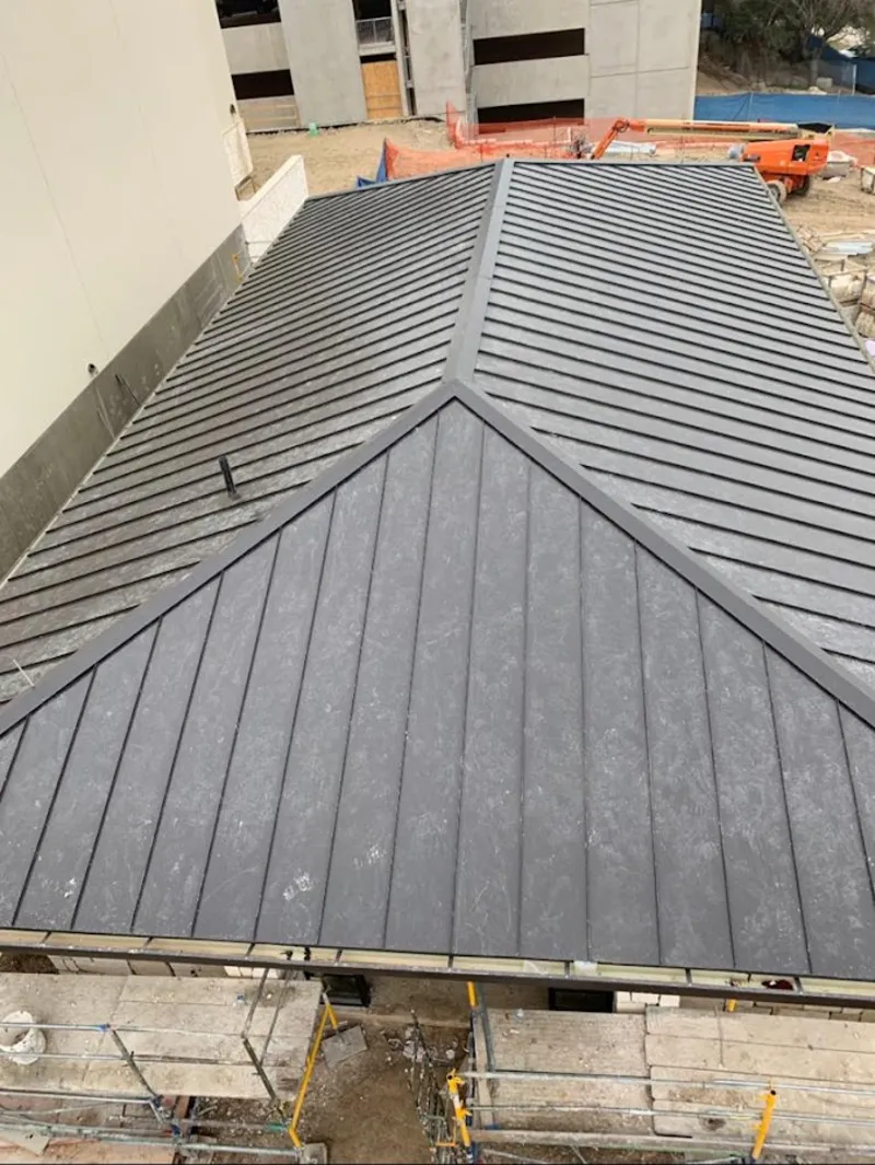 Commercial metal roof construction with crane equipment in New Hope